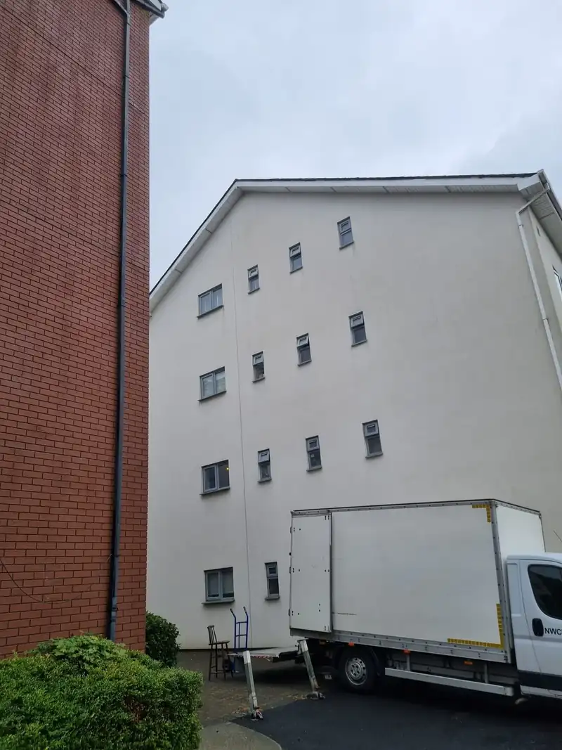 Property Clearance truck parked beside an apartment development