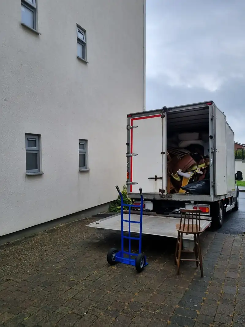 Furniture wheeled out of an apartment block on a trolley