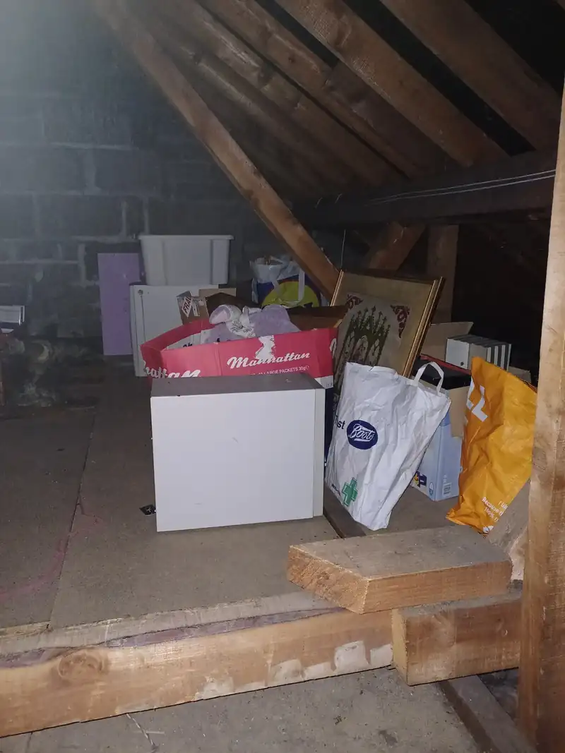 Boxes, bags and cases stored in an attic before clearance