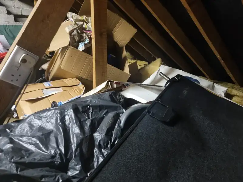 Attic stacked with bags and boxes before an attic clearance