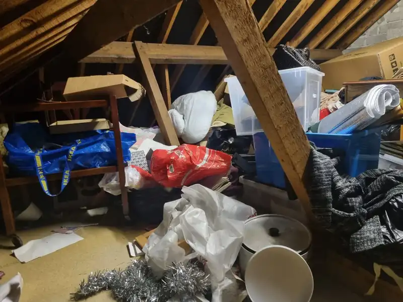 Attic full of stored items and bags before an attic clearance