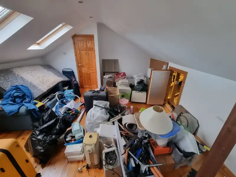 Attic room with accumulated belongings before Property Clearance arrived
