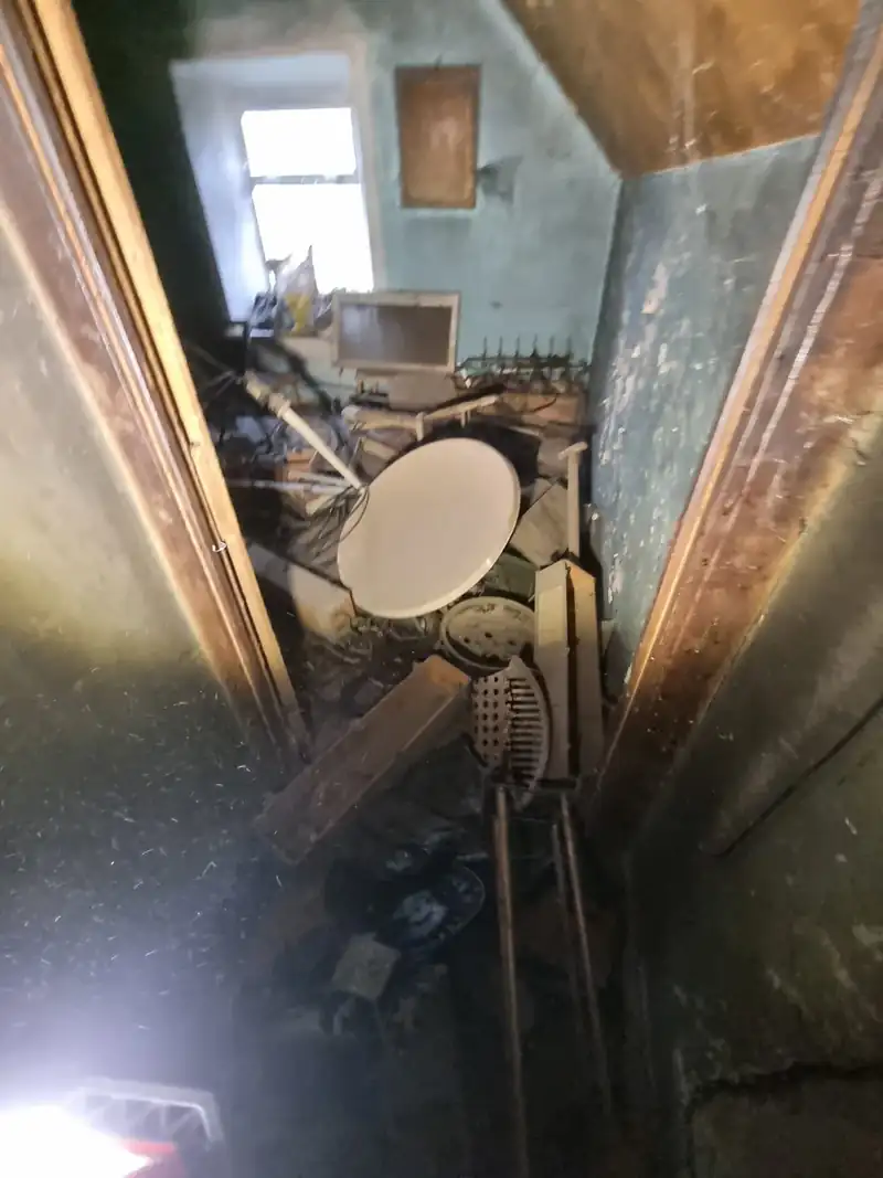Attic room full of junk and old fittings before clearance