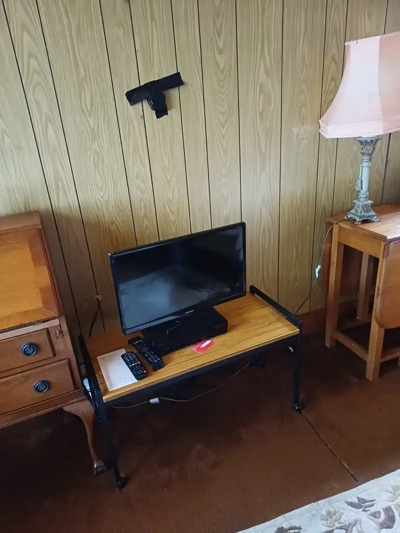 Bedroom furniture and television before a house clearance
