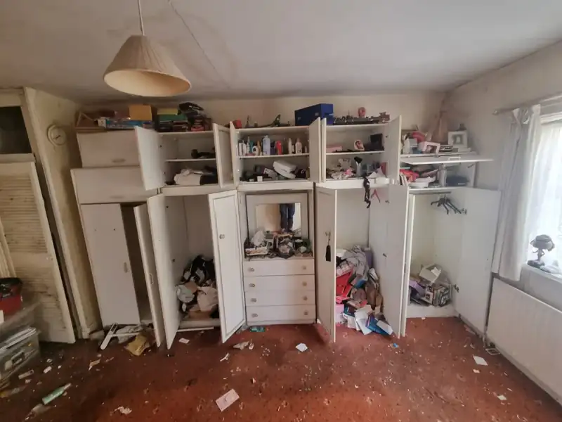 Built-in wardrobes and cupboards being emptied during a house clearance