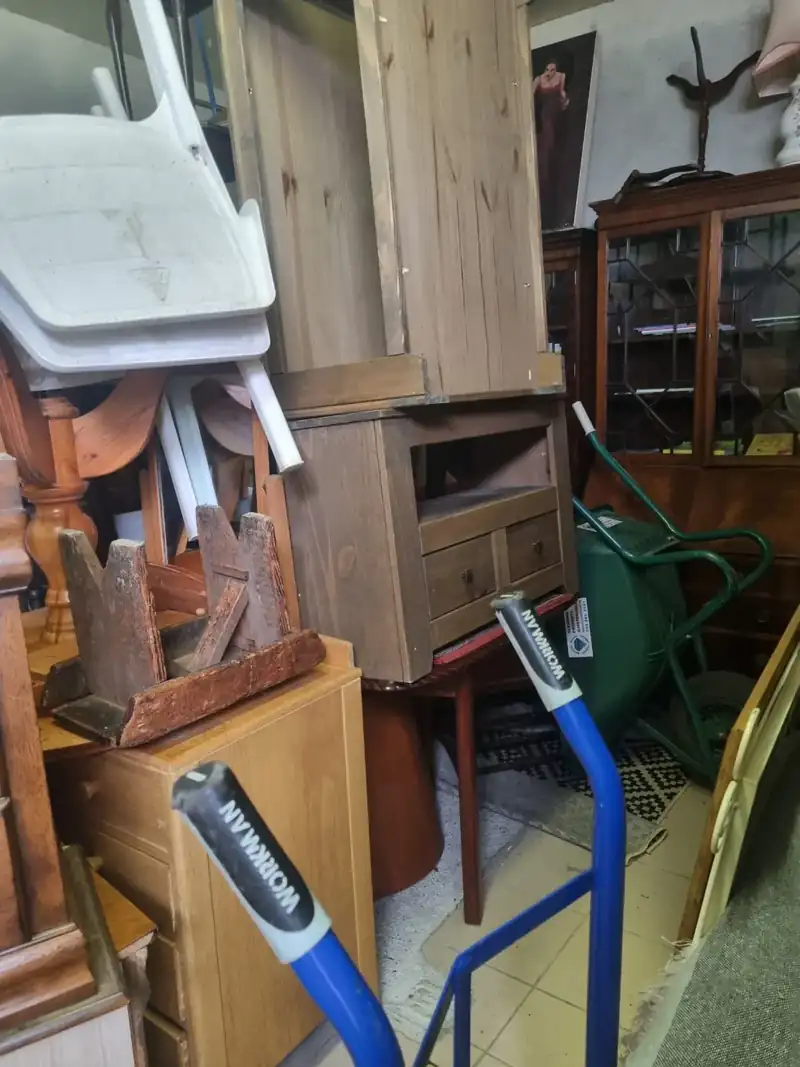 Furniture being moved out on a trolley during a clearance