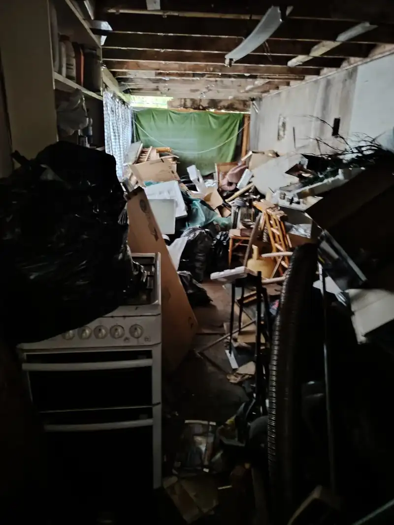Garage full of junk, timber and old furniture before clearance