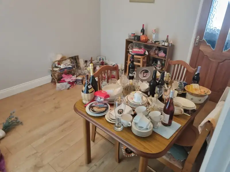 Dining room contents being sorted during a full house clearance