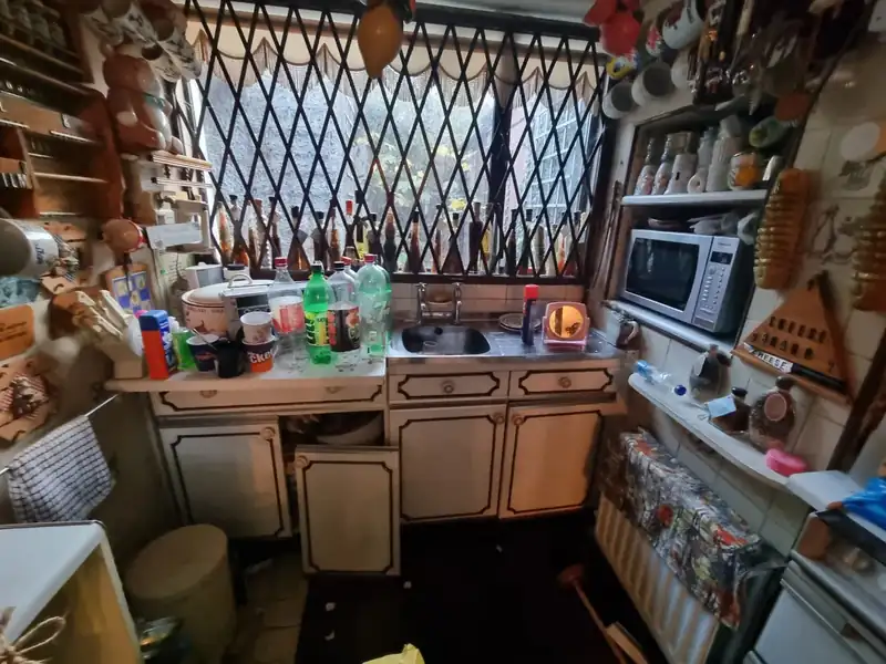 Kitchen cluttered with household items before a property clearance