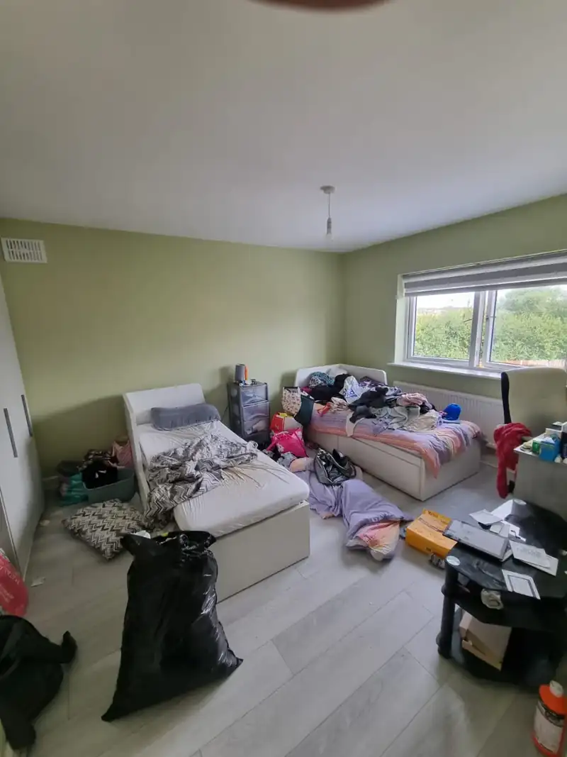 Living room with furniture and belongings before a house clearance