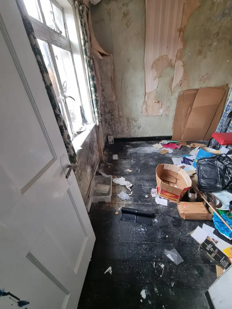 Room with rubbish and debris left behind before an end-of-tenancy clearance