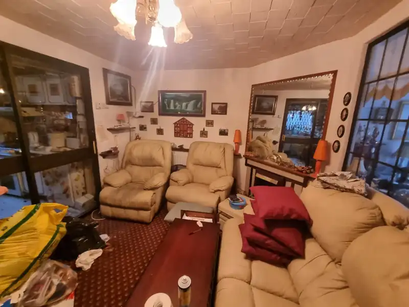 Sitting room full of furniture and belongings before a bereavement clearance