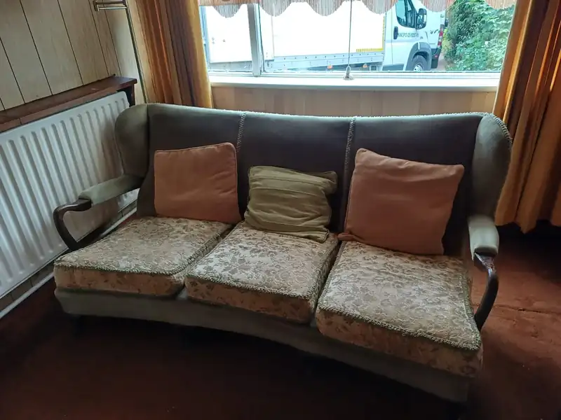 Three-seater sofa ready for removal during a house clearance