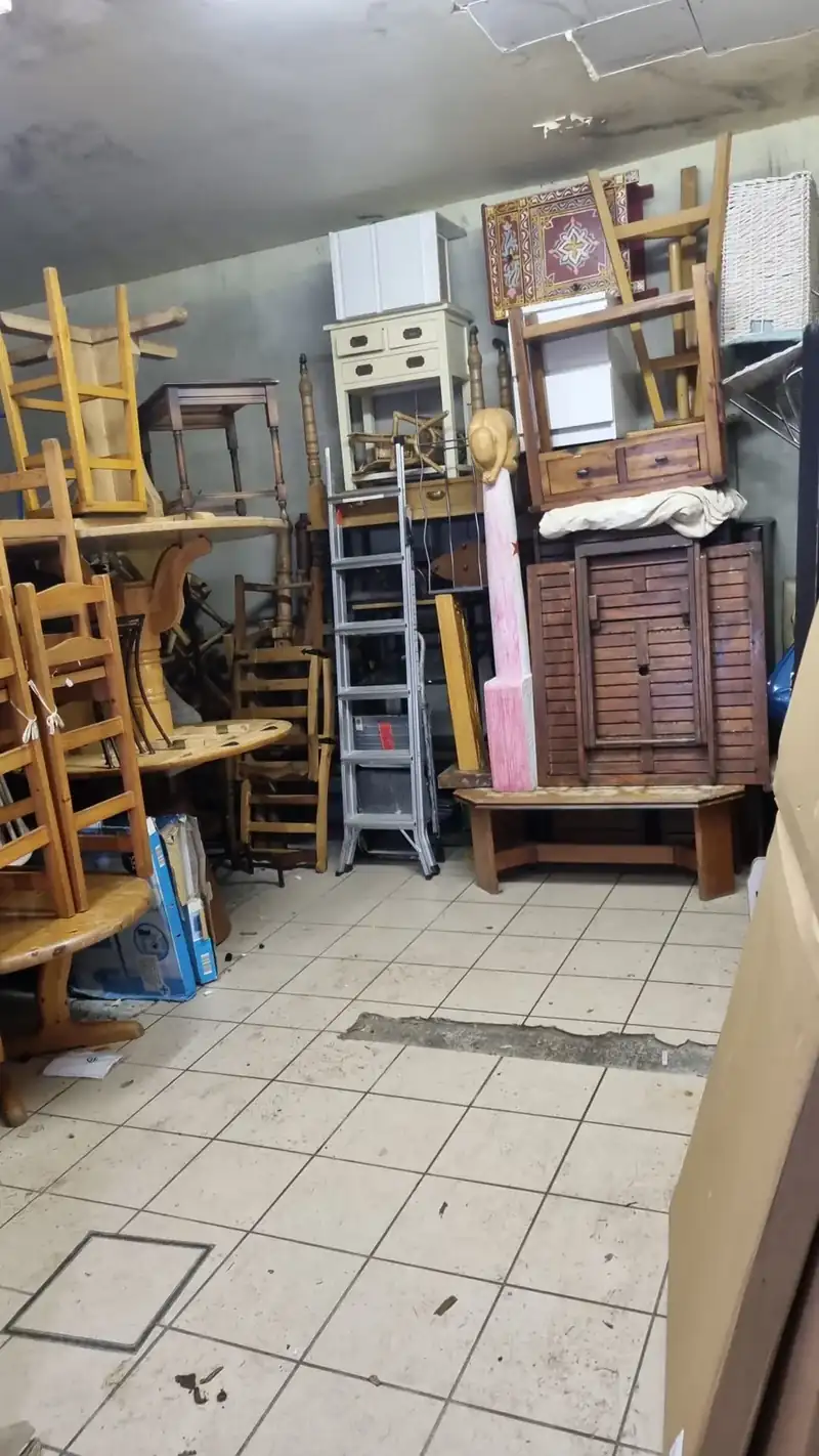 Workshop with stacked chairs and furniture being cleared