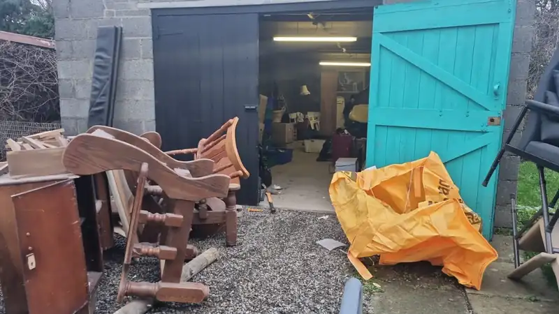 Furniture and bags brought out to the yard during a clearance